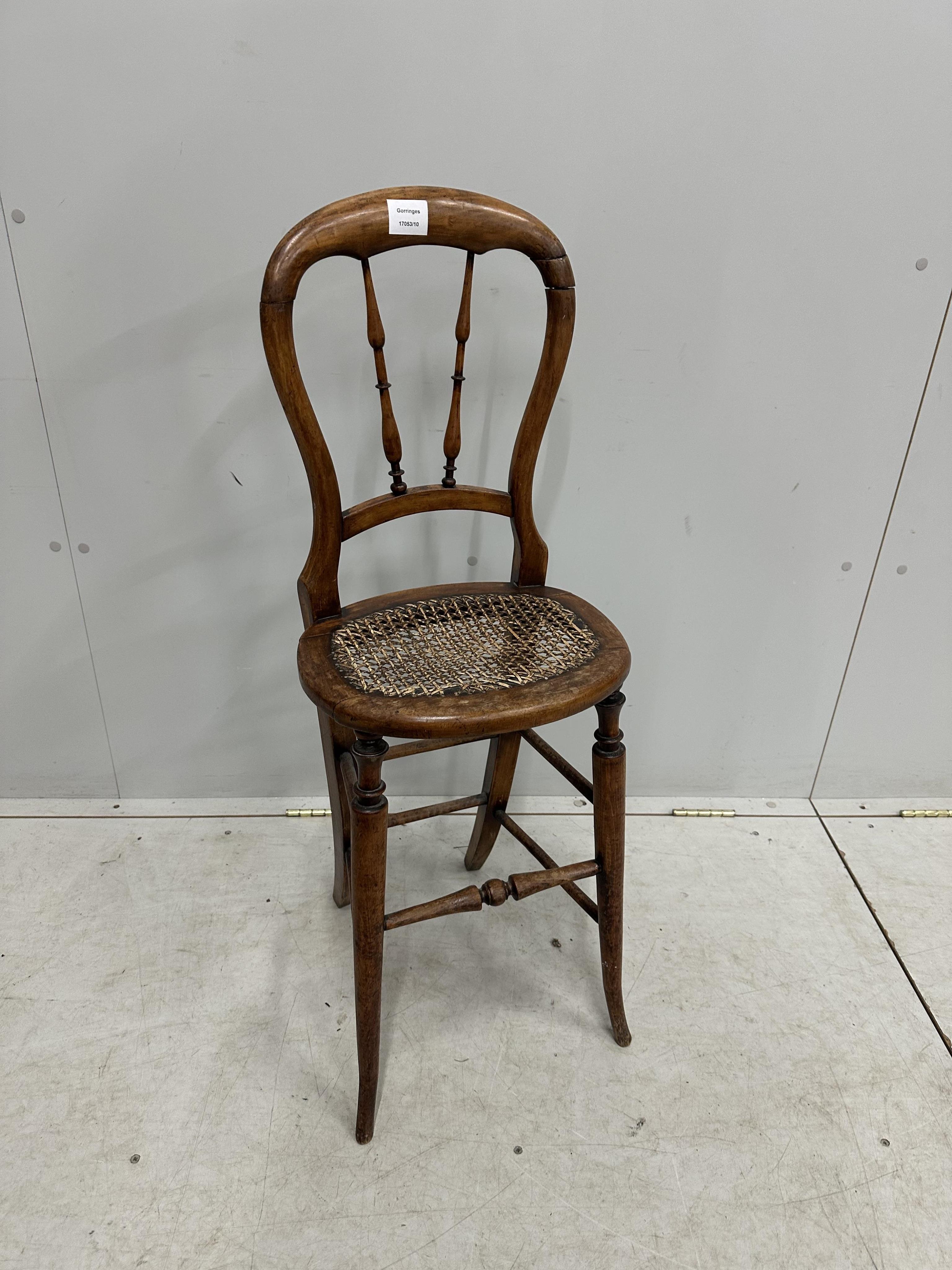 A Victorian beech cane seat correction chair, height 96cm. Condition - fair